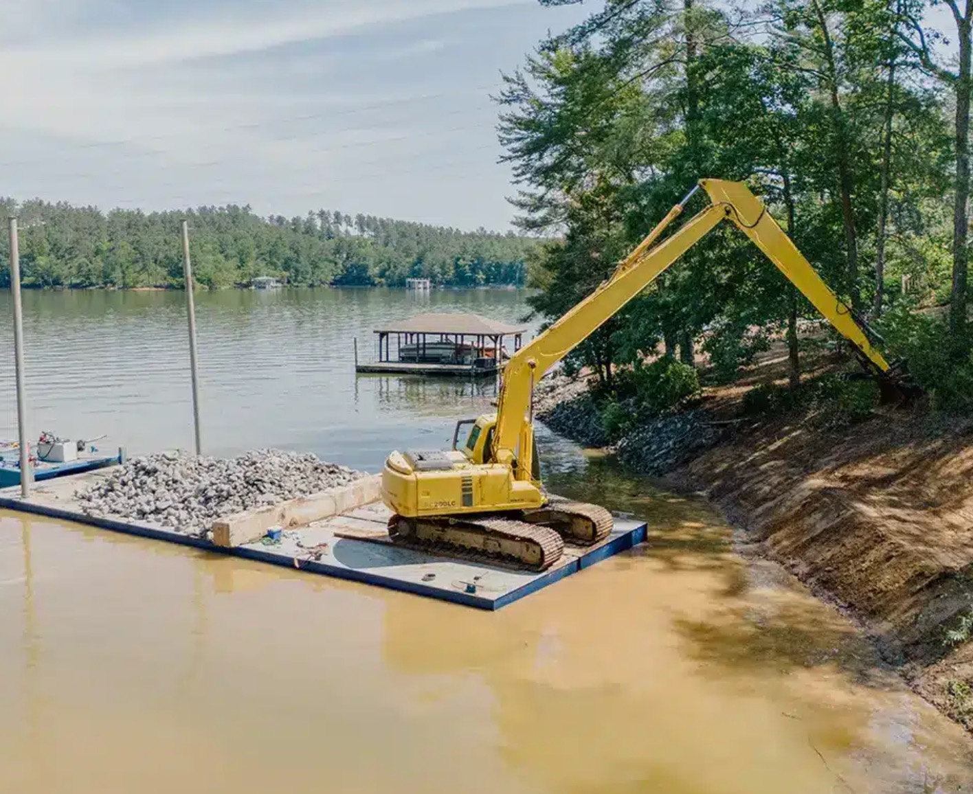Excavator on barge working shoreline